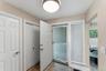 Entry way featuring tiled flooring, a flush-mount ceiling light, white paneled doors, and a front entry door with an adjacent window
