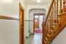 Hallway featuring arched walkways, tile patterned flooring, and stairs