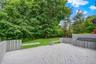 Spacious outdoor deck with painted wood flooring and slatted perimeter fencing