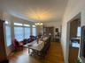 Dining space with hardwood / wood-style floors, crown molding, and an inviting chandelier