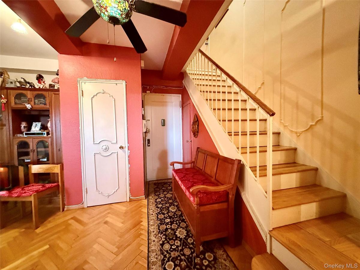 Main entrance on the 9th floor, hardwood floors, coat closet, storage under stairs, open to the dining area
