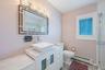 Bathroom featuring a baseboard radiator, vanity, a shower stall, and wood finished floors