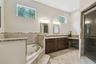Owners bathroom with a jetted tub and walk in shower.