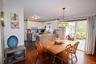 Dining area with hardwood-finish flooring and a stained-glass pendant light fixture