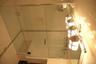 Bathroom featuring combined bath / shower with glass door
