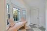 Mudroom featuring light flooring and baseboards