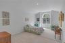 Spacious room featuring a large arched window, vaulted ceiling, recessed lighting, and neutral carpet flooring. Walk in Closet