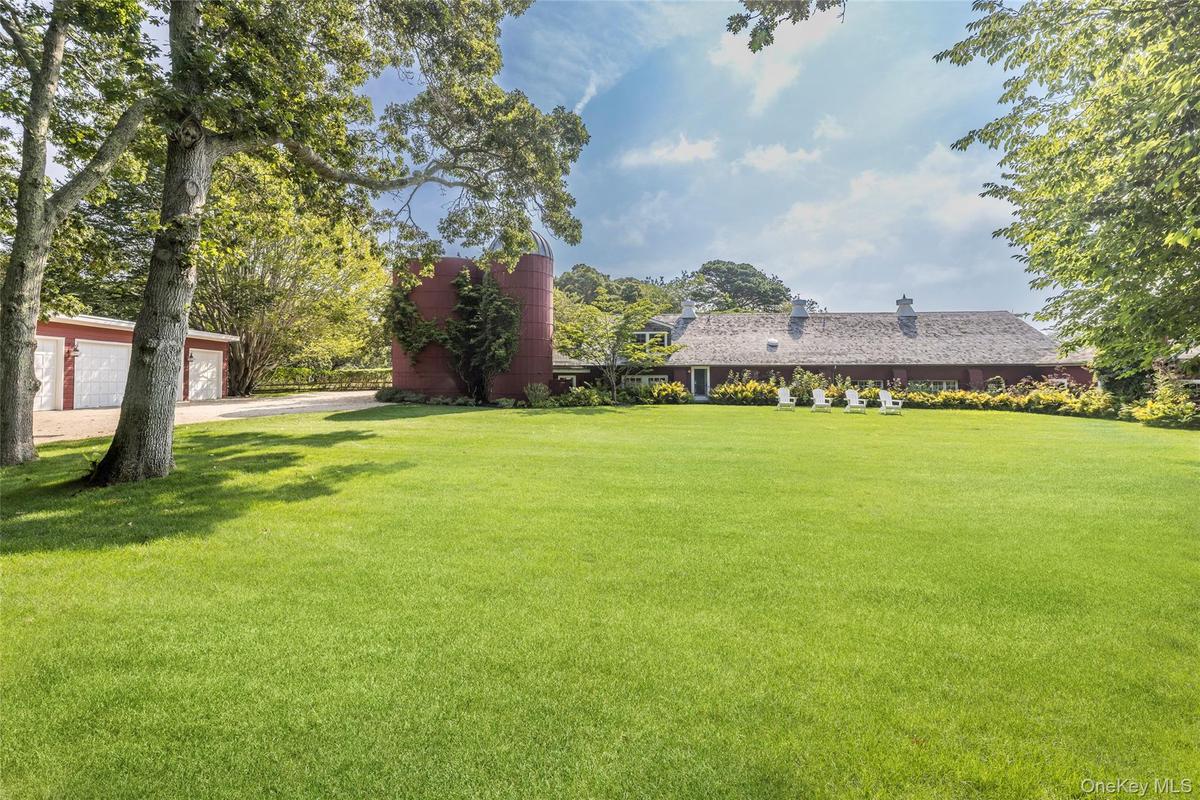 View of grassy yard with an outbuilding
