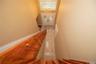 Stairway leading from second floor leading to the front door with grand entrance