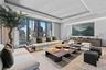 Living area featuring a tray ceiling and recessed lighting