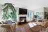 Living room featuring a glass covered fireplace and lofted ceiling