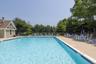 Rectangular swimming pool with a concrete deck surround