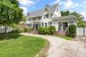 Front of Structure – Beautifully maintained front exterior featuring timeless architectural styling, steep gabled rooflines, mature landscaping, and a