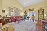 Living room with high vaulted ceiling, dark wood-style floors, and recessed lighting