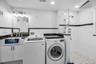 Upstairs laundry room with a full guest bath.