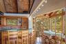 Bar featuring wooden ceiling, indoor wet bar, wood finished floors, vaulted ceiling with beams, and a sink