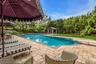 L-Shaped tiled gunite saltwater gas heated pool, with attached circular in-ground spa