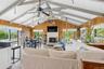 Vaulted ceiling featuring exposed beams and wood-paneled walls