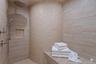Walk-in shower featuring a built-in bench, rain shower head, hand-held shower, recessed niche, and mosaic tile accent wall
