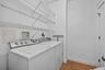The main-level laundry room adds everyday convenience with shelving and a closet for household storage.