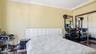 Bedroom with ornamental molding and dark wood finished floors
