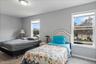 Bright room featuring two large windows with white trim, light gray painted walls, Can house a King- Sized Bedroom Set, Deep Closet