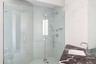 Bathroom with a stall shower and a sink