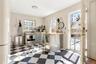 Bar with refrigerator, dishwashing machine, stainless steel range with electric stovetop, and tile patterned floors