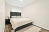 Bedroom featuring dark wood-type flooring and baseboards