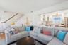 Living area with crown molding and stairway