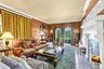South facing den, 9.5 ft ceilings, featuring ornamental molding, huge fireplace, arched windows facing the lakes, solid wood floors