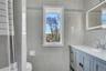 2nd Floor- Full bath featuring vanity, tile walls, and curtained shower