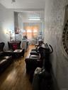Living area featuring a textured wall and wood-type flooring