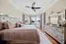 Primary bedroom has panoramic lake views and a private access to the lanai/pool deck