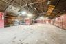 Miscellaneous room featuring lofted ceiling, metal wall, and a garage
