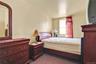 Bedroom featuring dark carpet