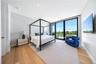Bedroom with floor to ceiling windows and light wood finished floors