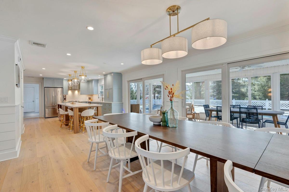 Dining space with light wood finished floors and recessed lighting