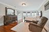 Bedroom with french doors, crown molding, and dark wood-type flooring