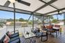 Large covered deck overlooking pool