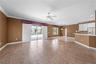 Family room opens up to large screened lanai and pool.