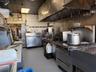 Kitchen featuring decorative backsplash, tile patterned floors, and stainless steel countertops