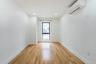 Unfurnished room featuring a wall unit AC, light wood finished floors, and recessed lighting