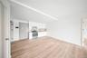 Kitchen featuring white cabinetry, stainless steel range with electric cooktop, light countertops, light wood-type flooring, and open floor plan