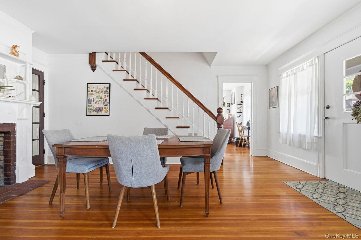 A natural gathering place, this inviting dining room links the home's main living spaces while showcasing an elegant fireplace and room for a large di