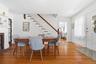 A natural gathering place, this inviting dining room links the home's main living spaces while showcasing an elegant fireplace and room for a large di