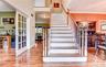 Grand staircase featuring wood treads and white risers