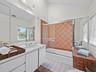 This bedroom enjoys a convenient ensuite.