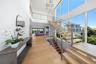 Staircase with a high ceiling, wood finished floors, a chandelier, and recessed lighting