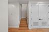 Staircase featuring baseboards and wood finished floors